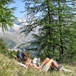 Katherine resting in larch meadow with Breuil-Cervina in background